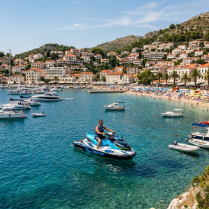 Blue catamaran named Solstice anchored near a coastal town with sunbathers on board and a crowded beach in background